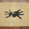 A handprint spider on a piece of paper.