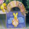 Fabric wrapped handle on small wooden box with rabbit motif.
