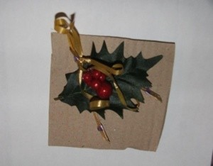 Christmas ornament made from painted wishbone and holly.