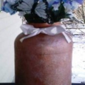 A flower vase made from a recycled jar.