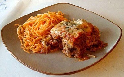 Meatloaf Parmesan on plate with spaghetti noodles