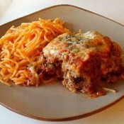 Meatloaf Parmesan on plate with spaghetti noodles