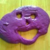 homemade purple silly putty in face shape