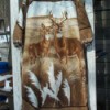 Dress made from a blanket with an image of a buck and doe deer in a field of wheat