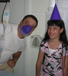 Dad with party hat over nose