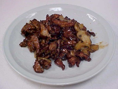 glazed chicken bits on a white plate