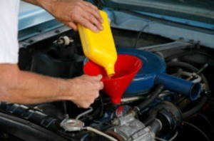 Adding oil to a car engine.