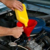 Adding oil to a car engine.