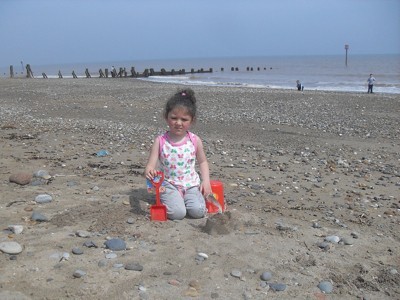 A girl playing at the beach in California.
