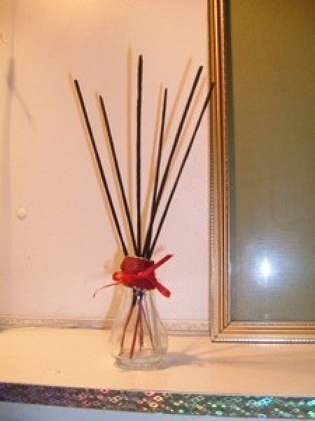 Several sticks of incense in a jar.