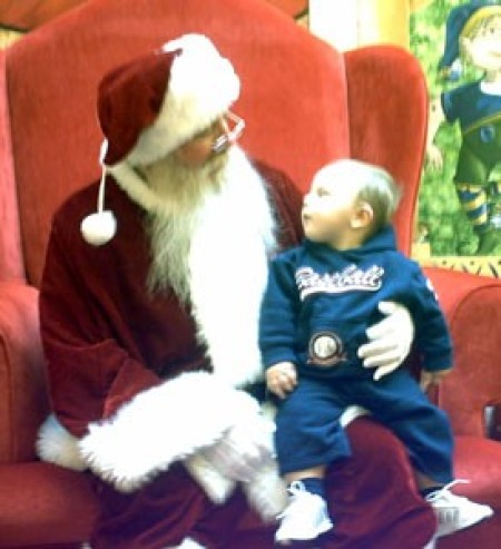 A baby in Santa's lap.