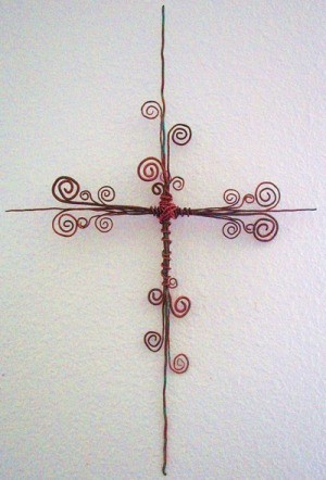 A wire cross with curlicues.