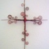 A wire cross with curlicues.