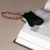 Felt bookmark in the shape of a mitten.