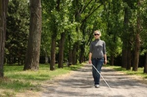 Blind woman walking in a park