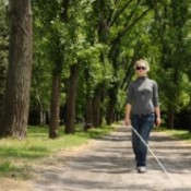 Blind woman walking in a park