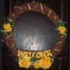 Decorated grapevine welcome wreath.