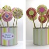 Paper flowers in recycled peanut can.