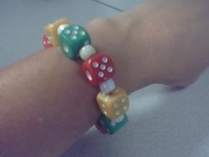 Dice and white bead bracelet.