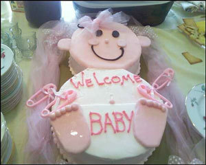 cake shaped like a baby with pink frosting