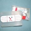 mini first aid kit with frowny face band aid on cover