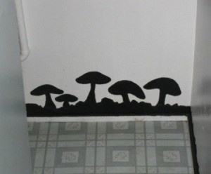 Black mushrooms painted on a wall to disguise water damage.