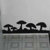 Black mushrooms painted on a wall to disguise water damage.
