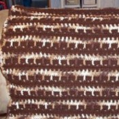 Brown and white crochet lapghan.