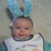 A baby with bunny ears on.