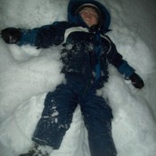 Boy making a snow angel.