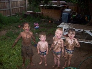 Photo of kids after playing in the mud.