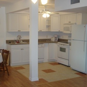 An empty white and beige kitchen.