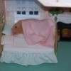 hamster on doll house bed