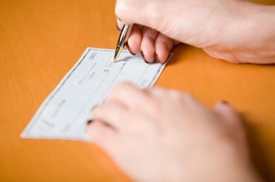 Woman writing a check.