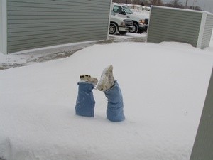 Legs and feet sticking out of snow.