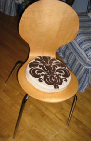 Circular pad on wooden chair.