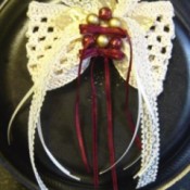 Crocheted hair bow with ribbon trim.