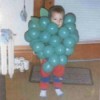 Little boy dressed as a bunch of grapes.