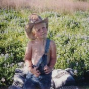 Boy in field of bluebonnets.