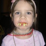 A girl with funny costume teeth.