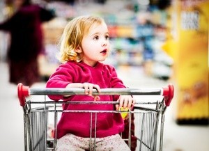 Young girl in shopping cart