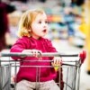 Young girl in shopping cart