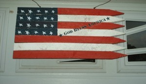 Stylized American flag made from fence pickets.