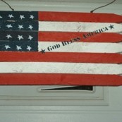 Stylized American flag made from fence pickets.