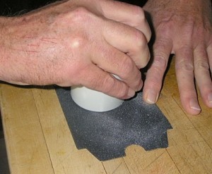 Sanding a craft part.