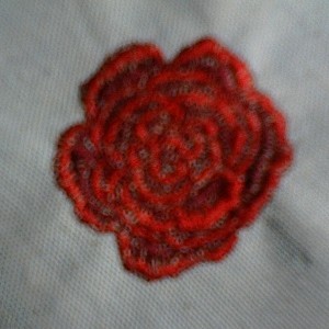 Red embroidered rose.