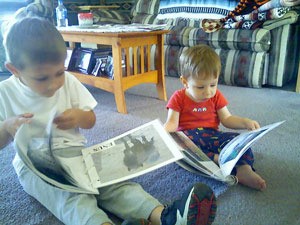 Children sitting on the floor looking at books.