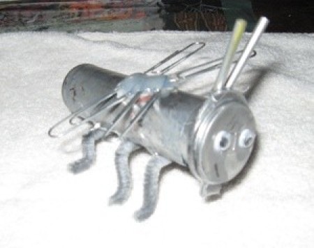 A silver ant made from recycled materials.