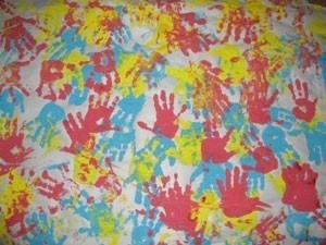 blue, yellow, and red handprints on paper