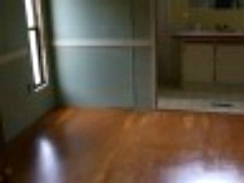 A stained wood flooring in an empty bedroom.